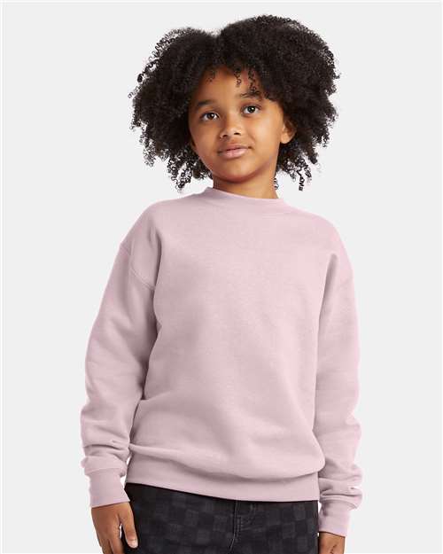 Hanes Youth EcoSmart® Crewneck Sweatshirt — Pale Pink — On model · front